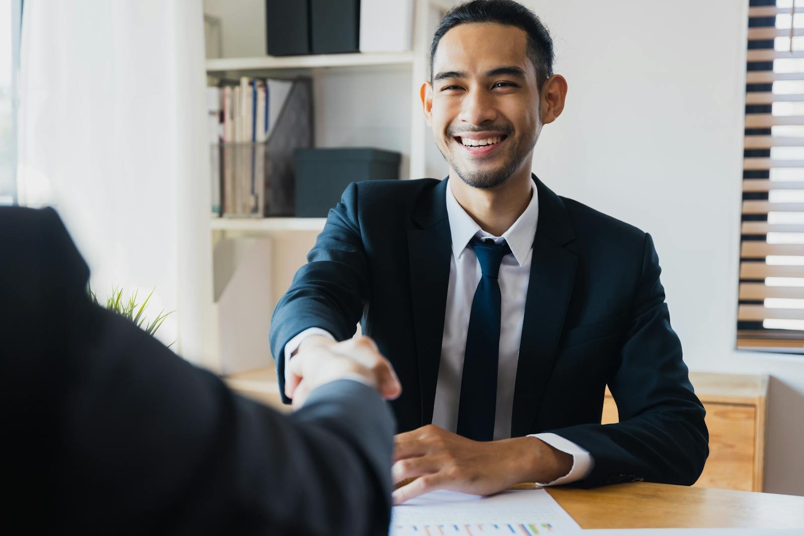A handshake across the counter